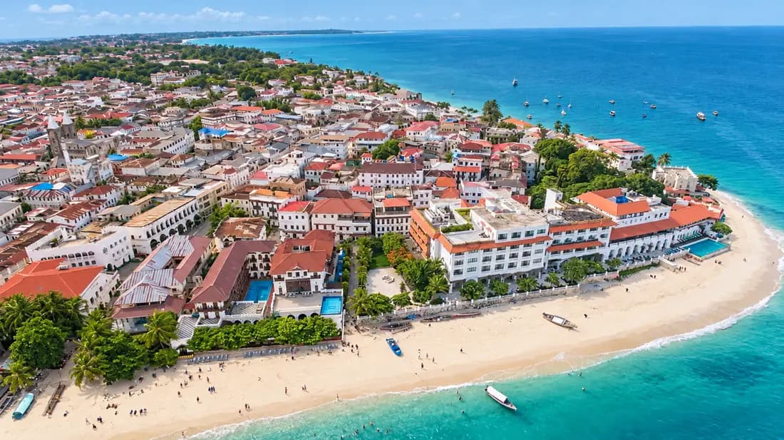 Sunlit Stone Town waterfront and Indian Ocean shore in Zanzibar